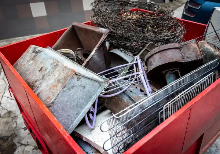 Skip loaded with scrap metal, including rusted tanks, wire and old appliance parts