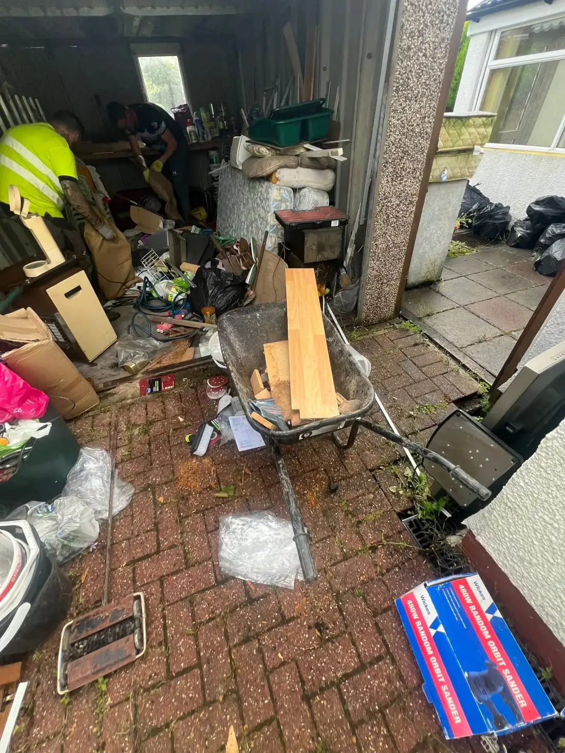 Garage crowded with tools, ladders and equipment