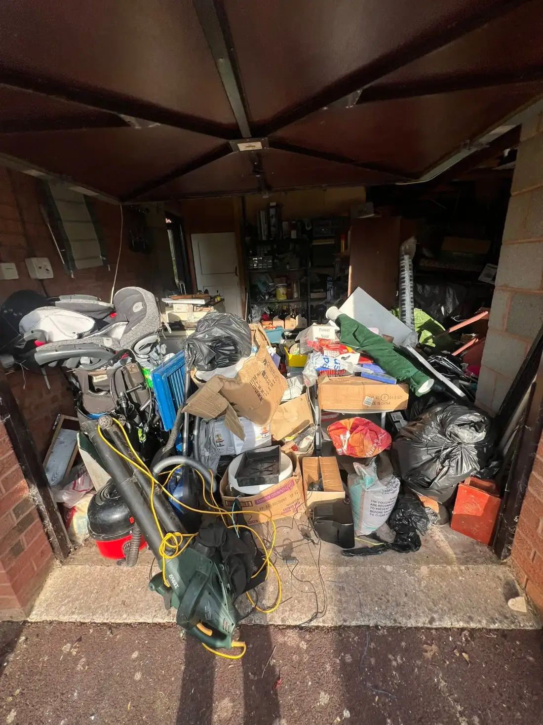 Garage filled with household items, tools and boxes